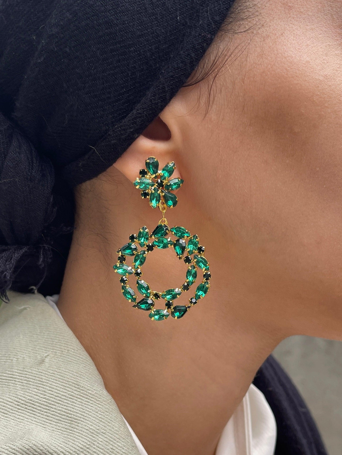 Close up on ear with Green emerald elegant geometric flower round hoop shape dangle drop fashion jewelry earrings - Roulette Safari