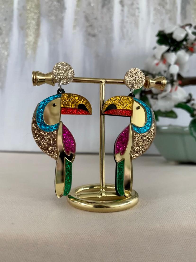 Acrylic glitter gold green pink turquoise red yellow tropical toucan parrot shape dangle drop fashion jewelry earrings on stand - Roulette Safari